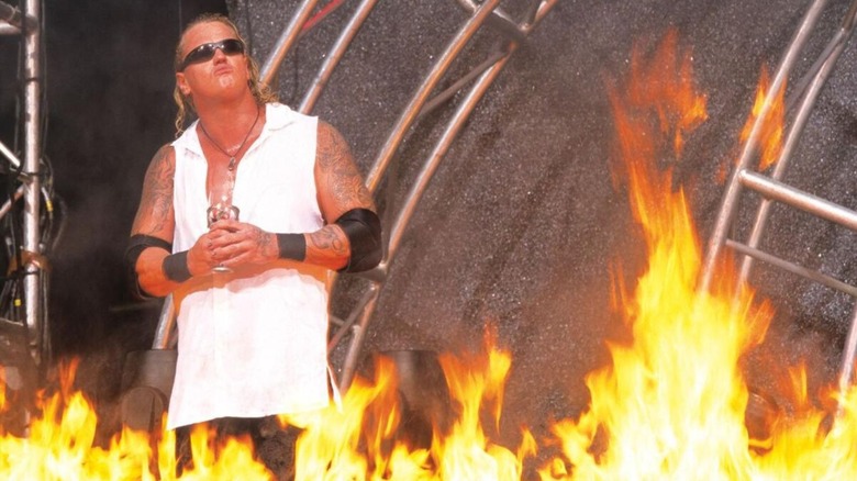 Gangrel poses with his cup of "blood" as his fire goes off during his entrance on an episode of WWE programming.