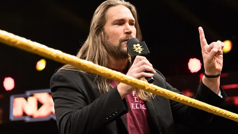 Chris Hero talking into a microphone