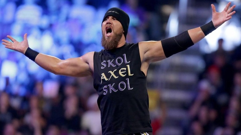 Curtis Axel, real name Joe Hennig, poses on the ropes before a match on an edition of WWE programming.