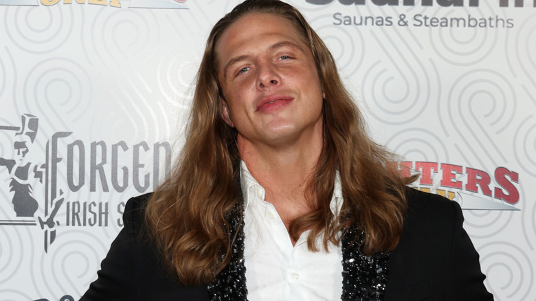 Matt Riddle is wearing a suit