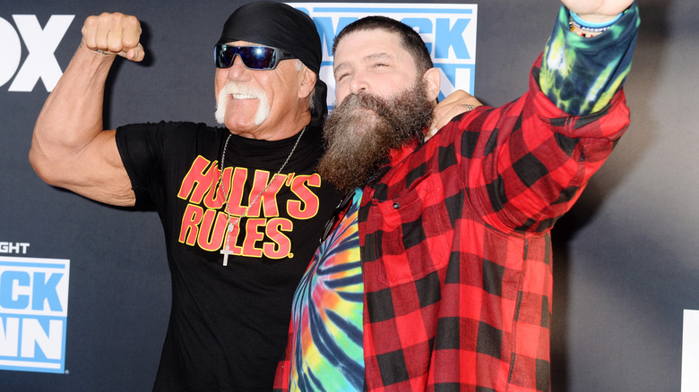 WWE Hall of Famers Hulk Hogan and Mick Foley pose together during a red carpet event promoting 