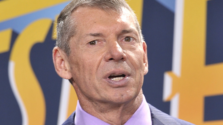 Vince McMahon speaking at a podium