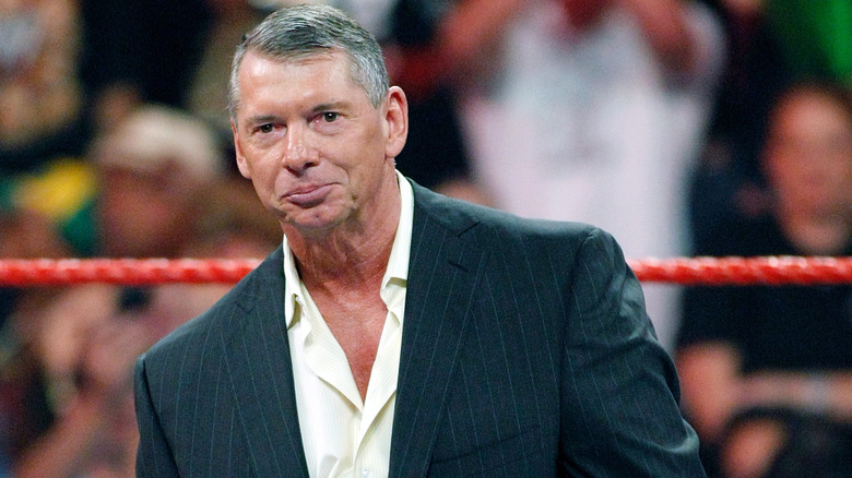Former WWE CEO and Chairman Vince McMahon looks out towards the crowd before giving an important announcement in the ring