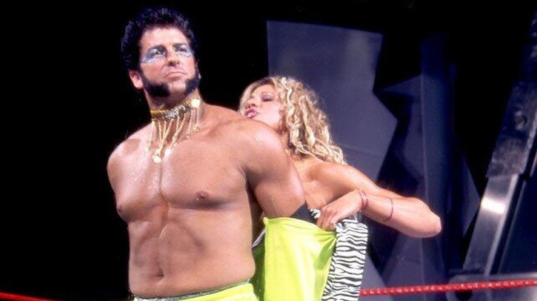 Rico having his coat taken off by Jackie Gayda during his entrance on an episode of 