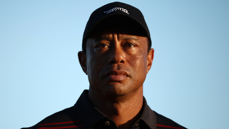 Tiger Woods stands on the 18th green for the trophy ceremony during the final round of the Hero World Challenge, 2025.