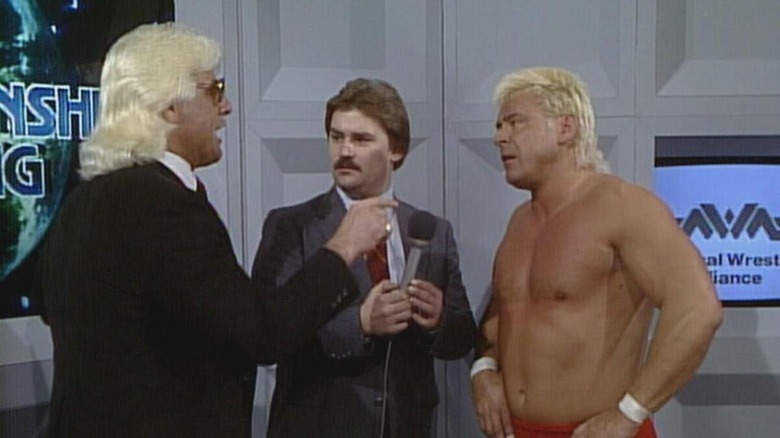 Ric Flair, Tony Schiavone, and Ron Garvin during a backstage promo segment at an NWA show.