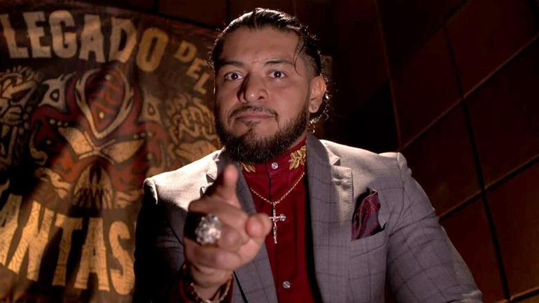 Santos Escobar pointing at the camera during a vignette promo segment.