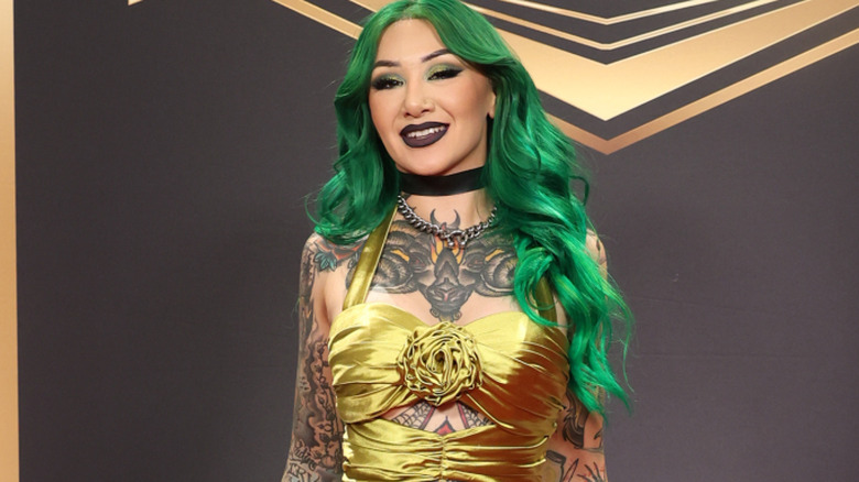 Shotzi wearing a gold dress