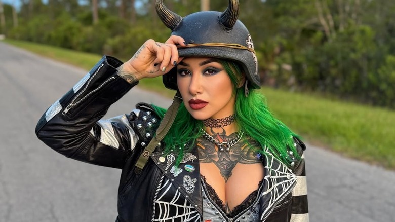 Shotzi posing in her entrance gear for an Instagram post sharing her July wrestling schedule.