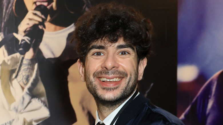 Tony Khan looking happy about signing a new talent