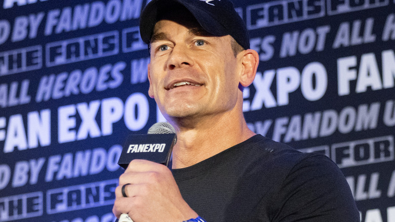 John Cena is holding a microphone