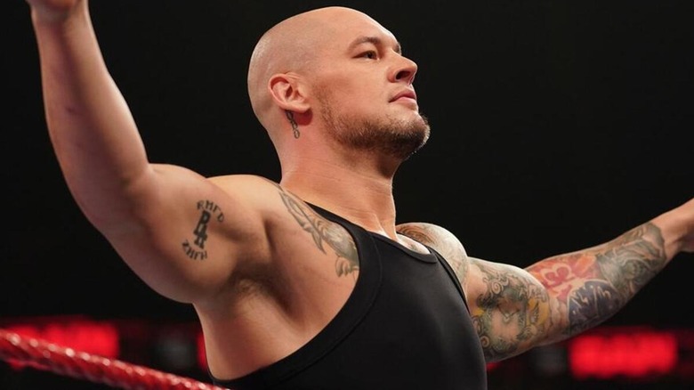 Baron Corbin, now known as Bishop Dyer, holds his arms out.