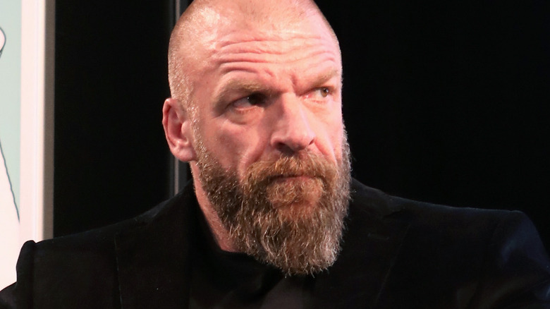 Triple H lookingto the side with a serious face