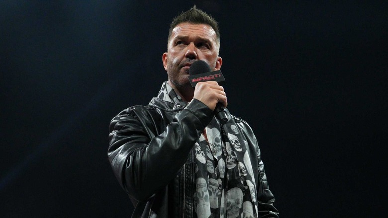 Frankie Kazarian holding a mic