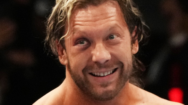 Kenny Omega smiles with black eye