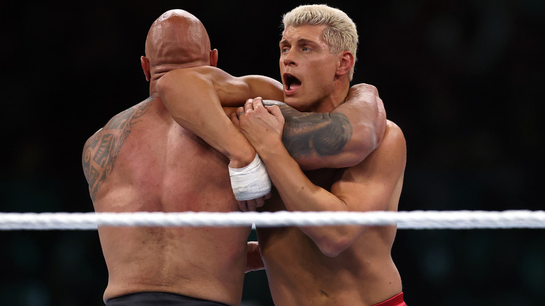 The Rock preparing to slam Cody Rhodes