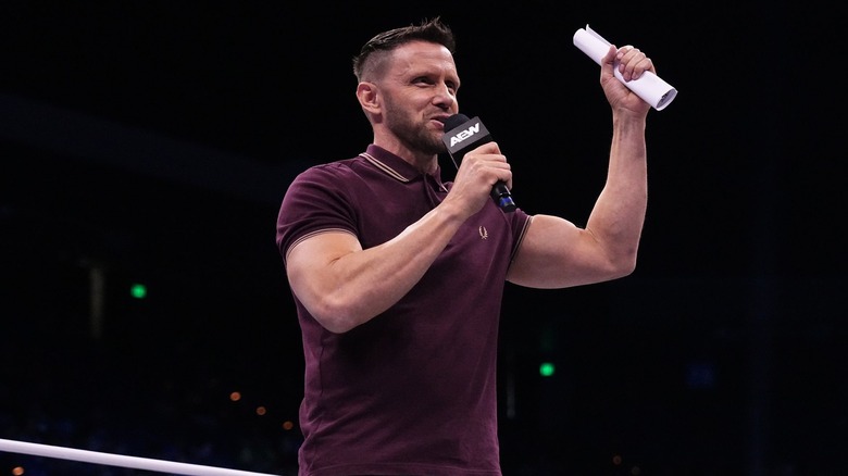 Nigel McGuinness brandishes the contract for his match