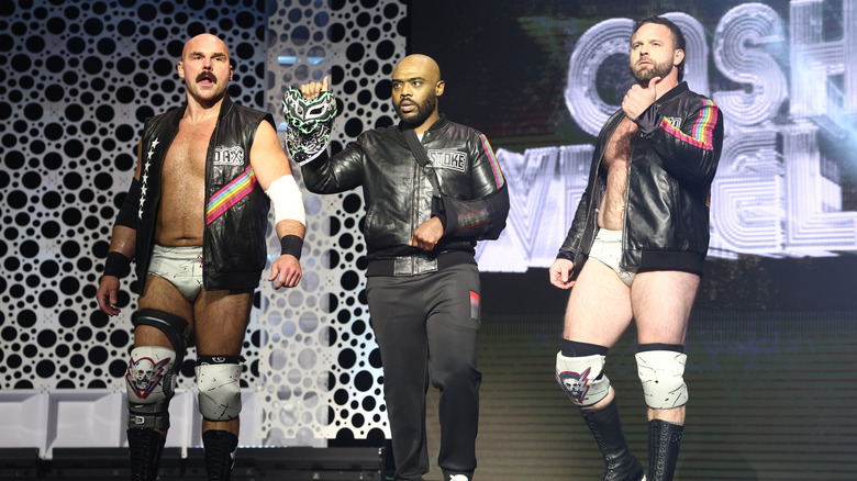 Dax Harwood, Stokely Hathaway, and Cash Wheeler make their way down to the ring before a match on 