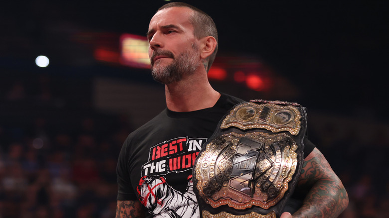 CM Punk holding his championship belt