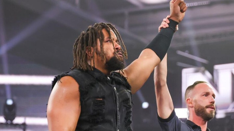 A referee raises the hand of Jasper Troy after a victory on an episode of "WWE NXT."