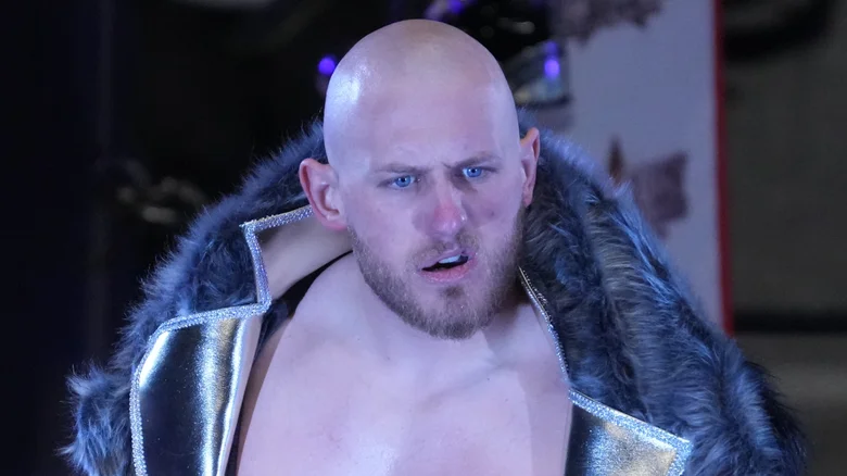 Gabe Kidd in ⁣ring, ‌intense expression, facing opponent.