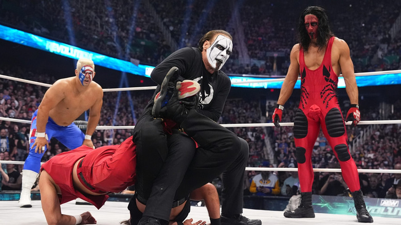 Sting with the Scorpion Death Lock on the Young Bucks while his sons look on