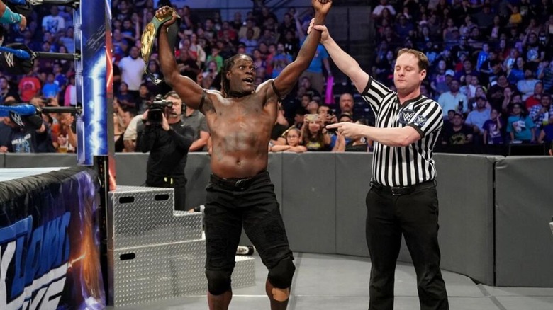A referee raises the hand of R-Truth after one of his victories for the 24/7 Championship on 