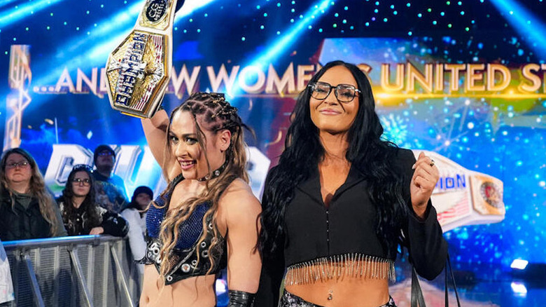 Giulia holds up the women's U.S. title while standing next to Kiana James