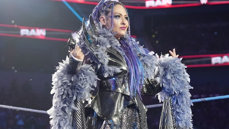 Giulia poses confidently in a feathered robe on an episode of 