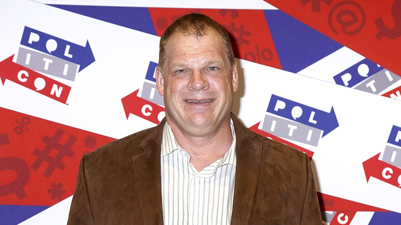 Glenn Jacobs standing in front of a whole lot of red, white, and blue
