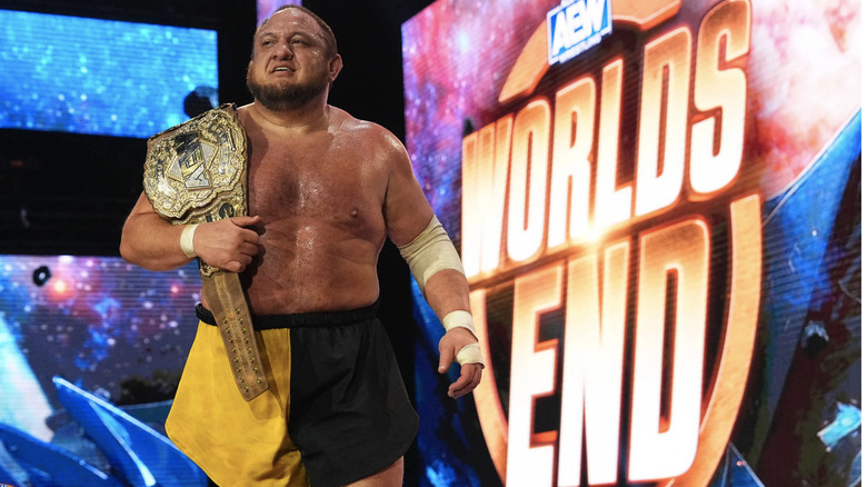 Samoa Joe with title belt on shoulder