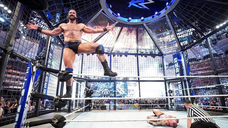 Drew McIntyre celebrates inside the Elimination Chamber