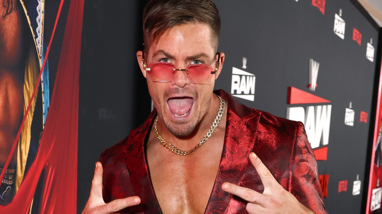 Grayson Waller wearing red sunglasses