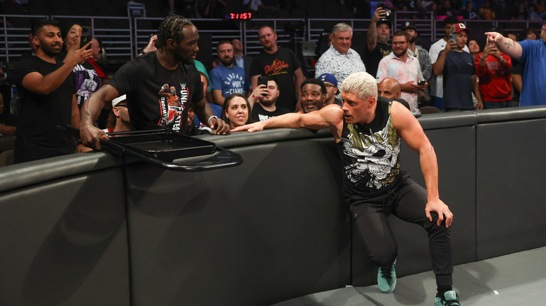 Terence Crawford hands Cody Rhodes a chair
