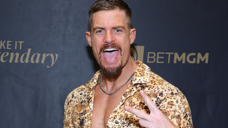 WWE star Grayson Waller gives a peace sign pose during a red carpet event in February