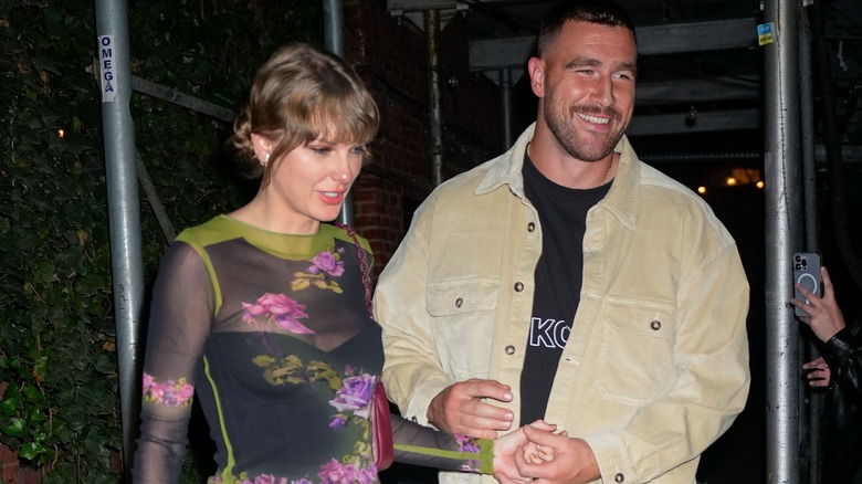 Taylor Swift and Travis Kelce holding hands