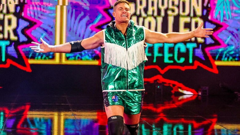 Grayson Waller poses on the stage as he heads down to the ring for a match on WWE programming.