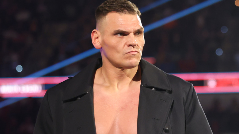 GUNTHER scowls as he dons his iconic trenchcoat.