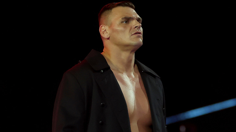 GUNTHER wearing a long, black coat