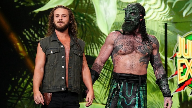 "Jungle" Jack Perry and Luchasaurus make their entrance as Jurassic Express.