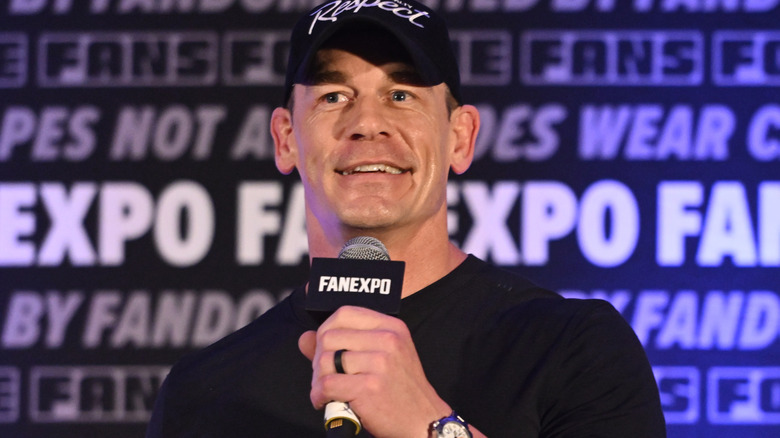 John Cena is holding a microphone