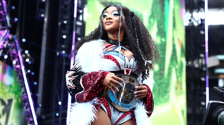 TBS Champion Maya World stands on the stage and looks toward the crowd during her entrance at AEW All In London 2026.