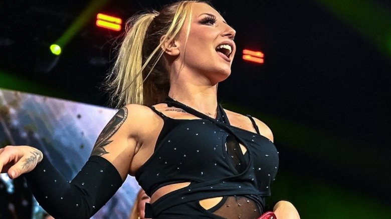 Heather By Elegance wearing a black top