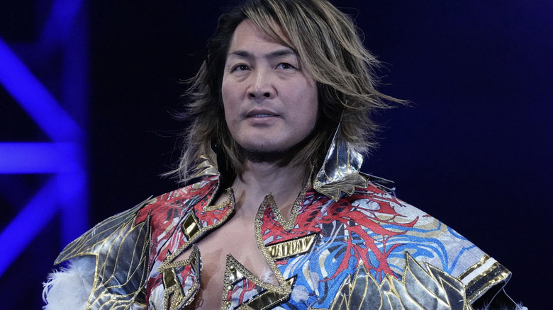 Hiroshi Tanahashi makes his entrance, cloaked in gold, black, red, white, and blue.