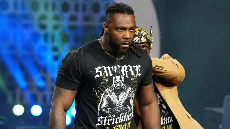Swerve Strickland, flanked by Prince Nana, makes his way down to the ring to get involved following Jon Moxley and Samoa Joe's steel cage match on "AEW Dynamite."