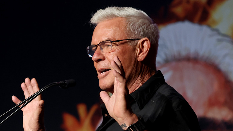 Eric Bischoff with his hands in the air