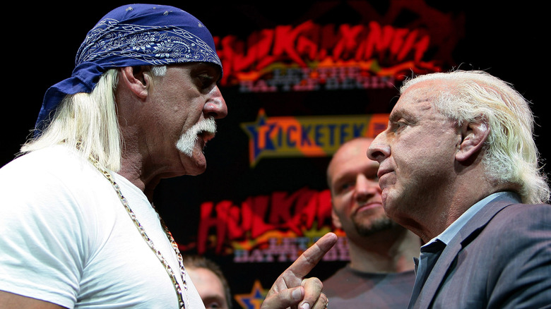 Hulk Hogan pointing finger at Ric Flair on stage during Hulkamania tour