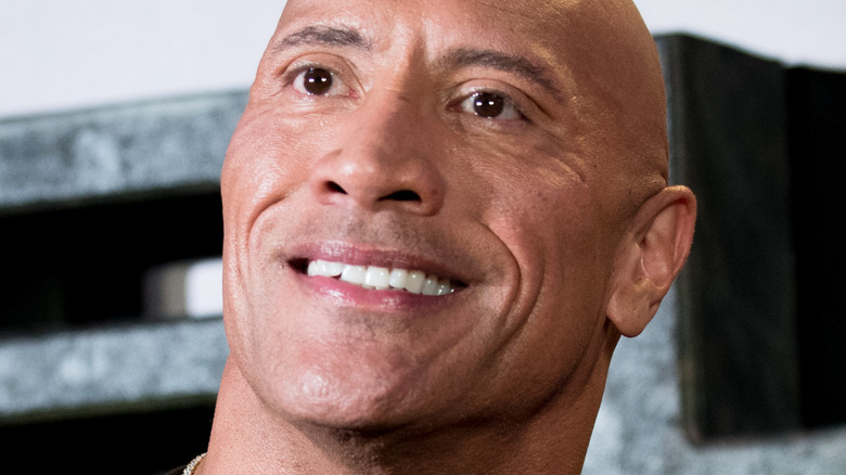 Dwayne Johnson smiles at a press event