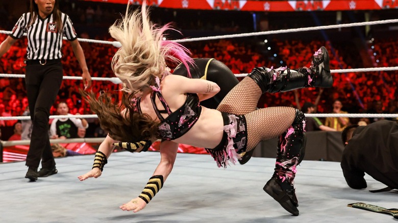 Alexa Bliss hitting Nikki Cross with her finisher