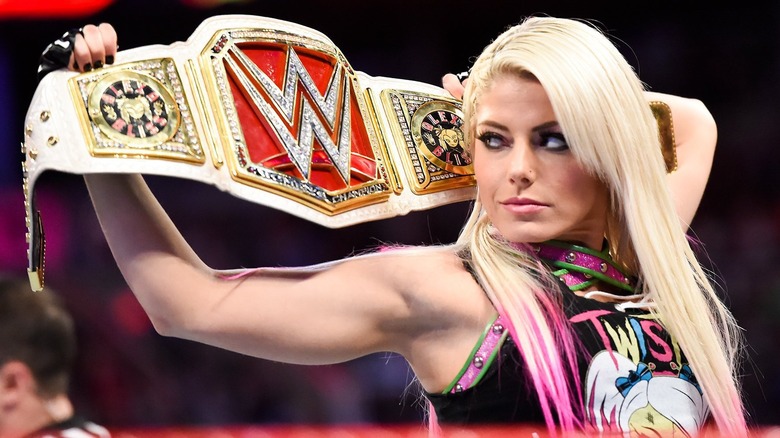 Alexa Bliss holding the WWE Raw Women's Championship